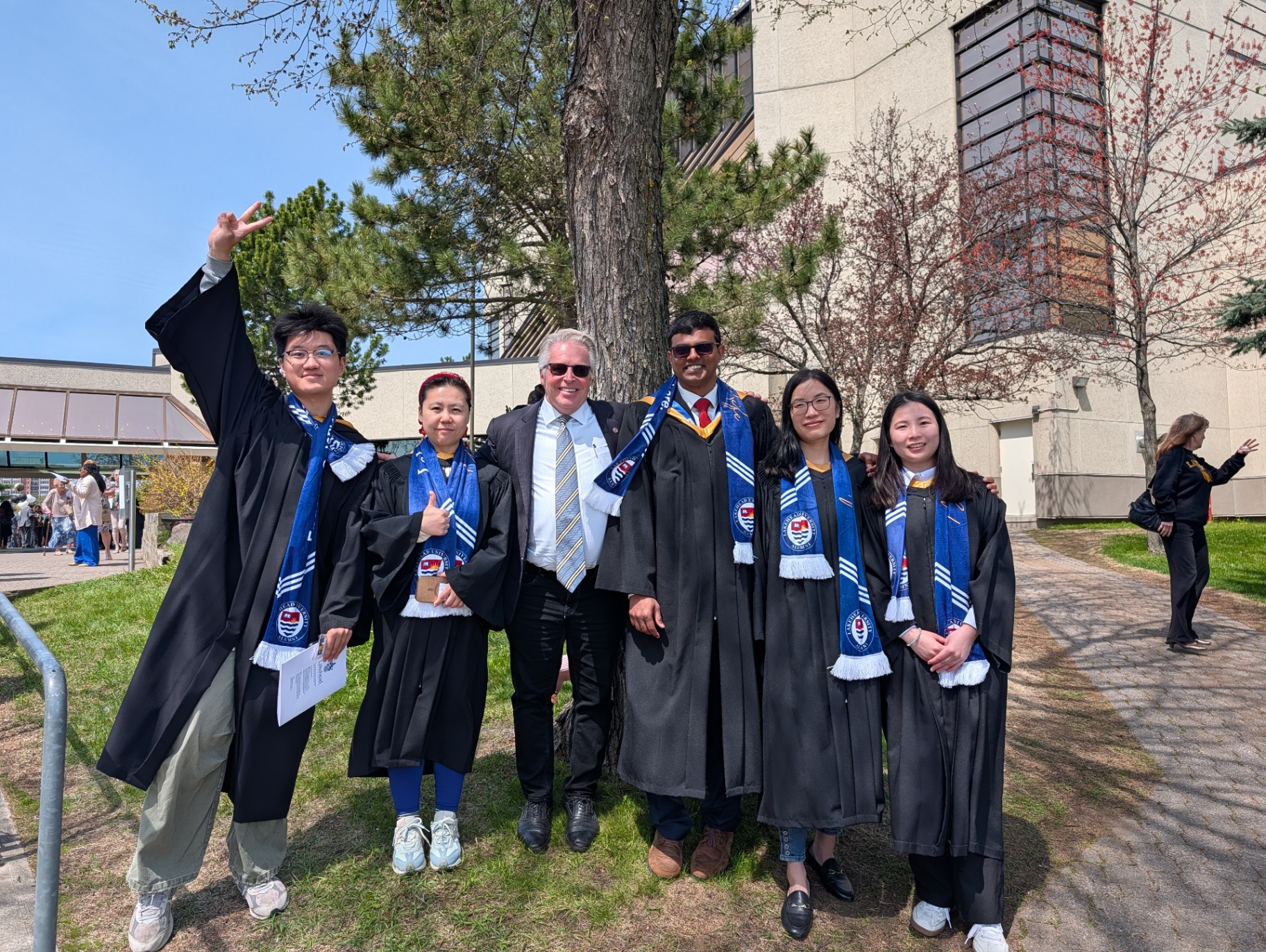 Peter Diedrich celebrating with graduating students