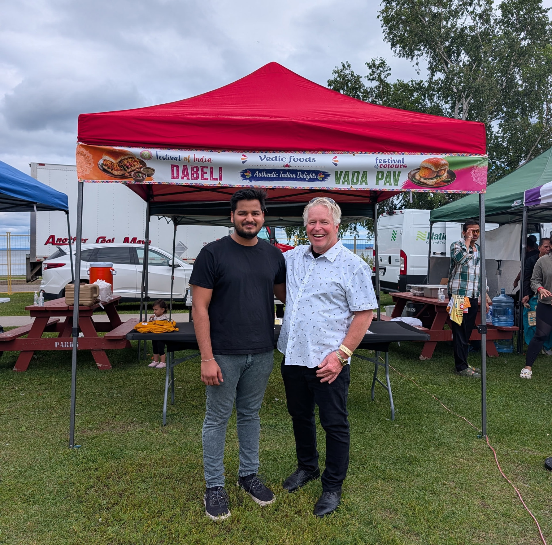 Peter Diedrich with a vendor at the Festival of India in Thunder Bay